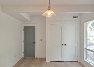 Residential painting project with a white room and green door